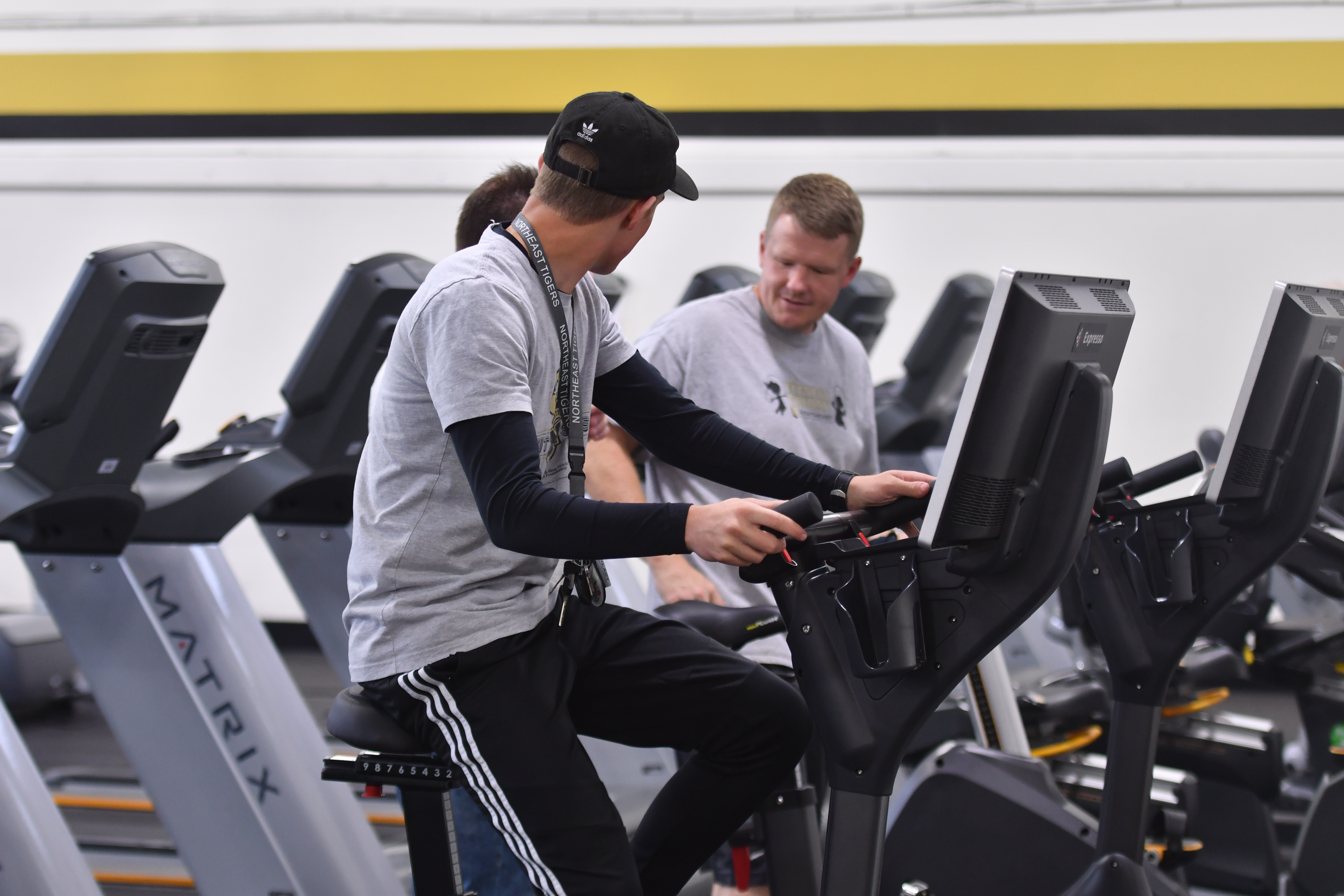 Photo of people talking inside the fitness center.