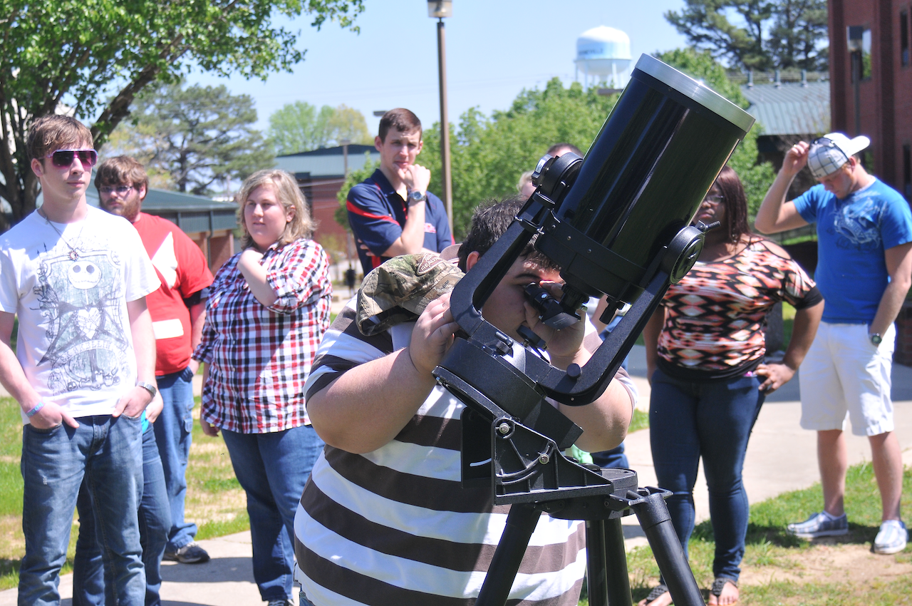 Photo of student looking through microscope