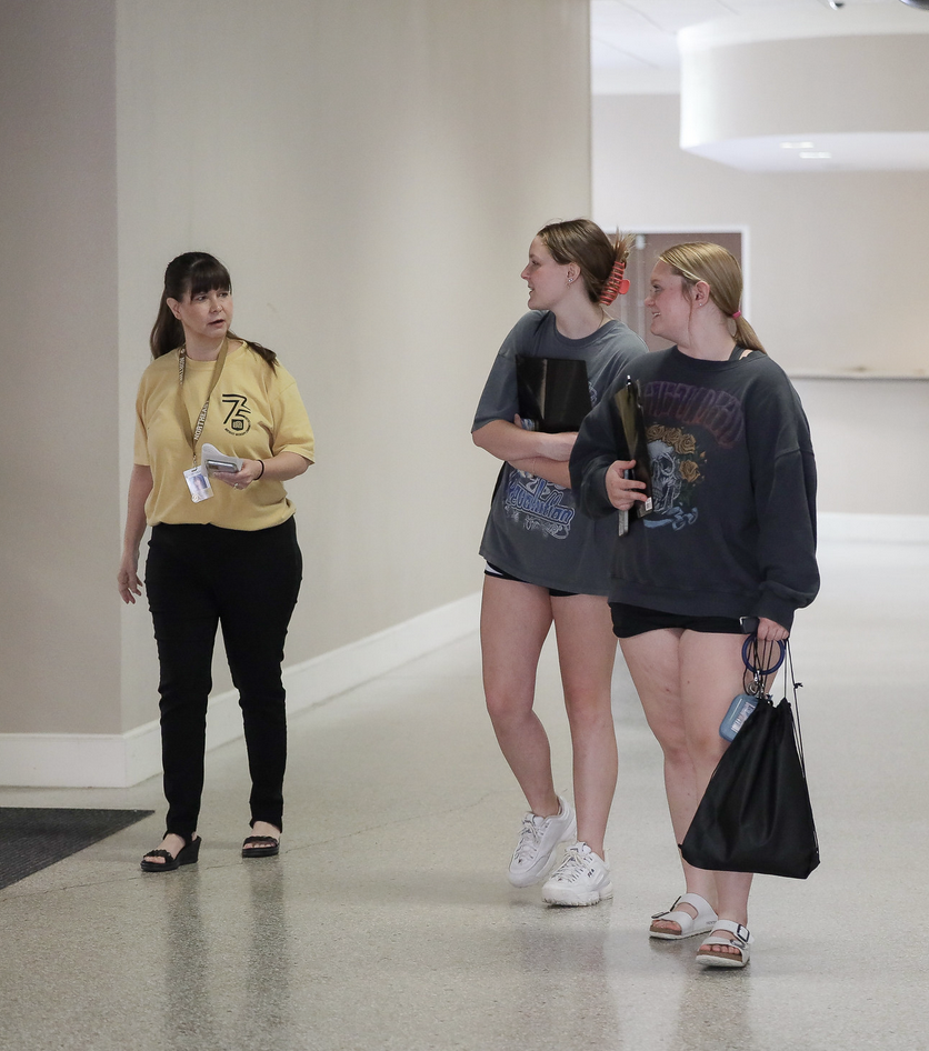 employee greeting students