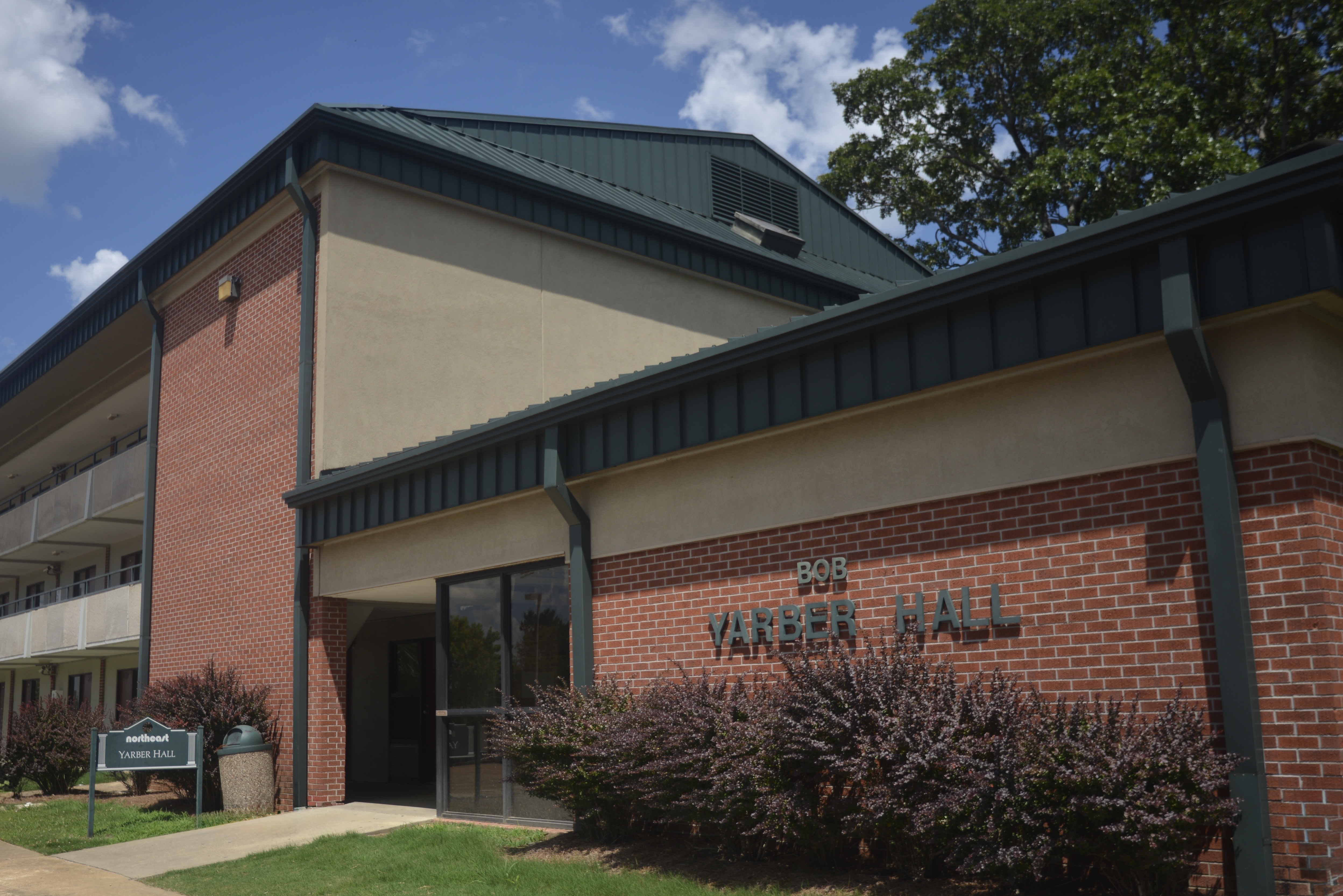 Exterior view of Bob Yarber Hall, featuring a brick facade and landscaped entrance.