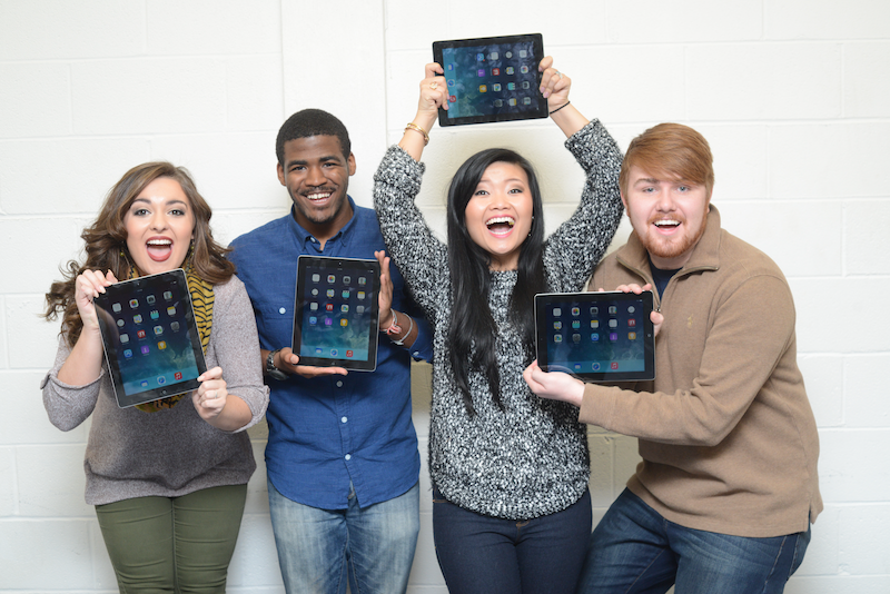 Photo of students holding iPads