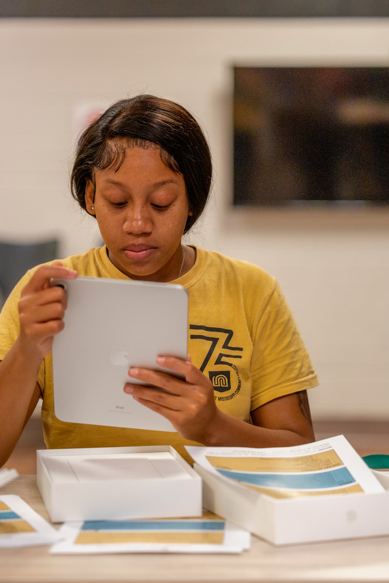 Female student turning on iPad.