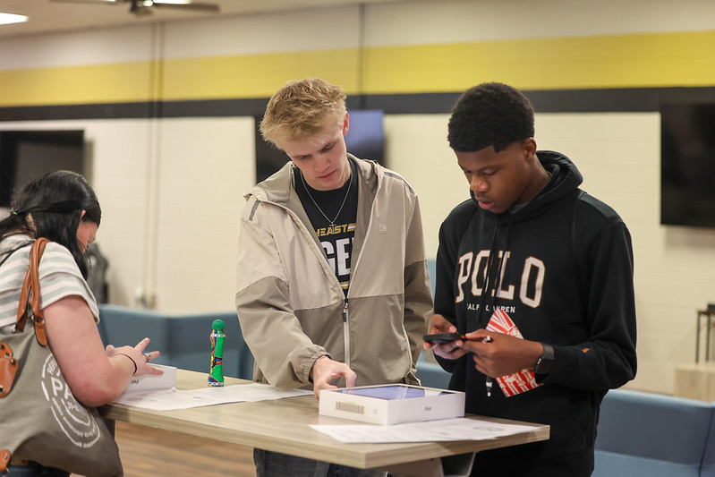 Photo of student setting up their iPad at iPad handout.