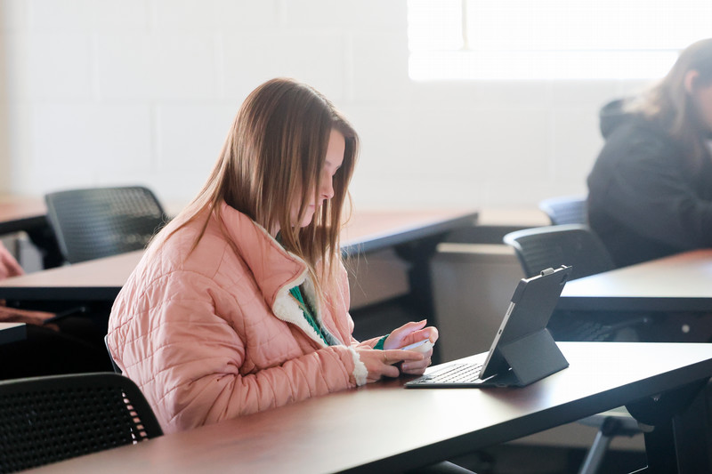 studnet in class looking at iPad